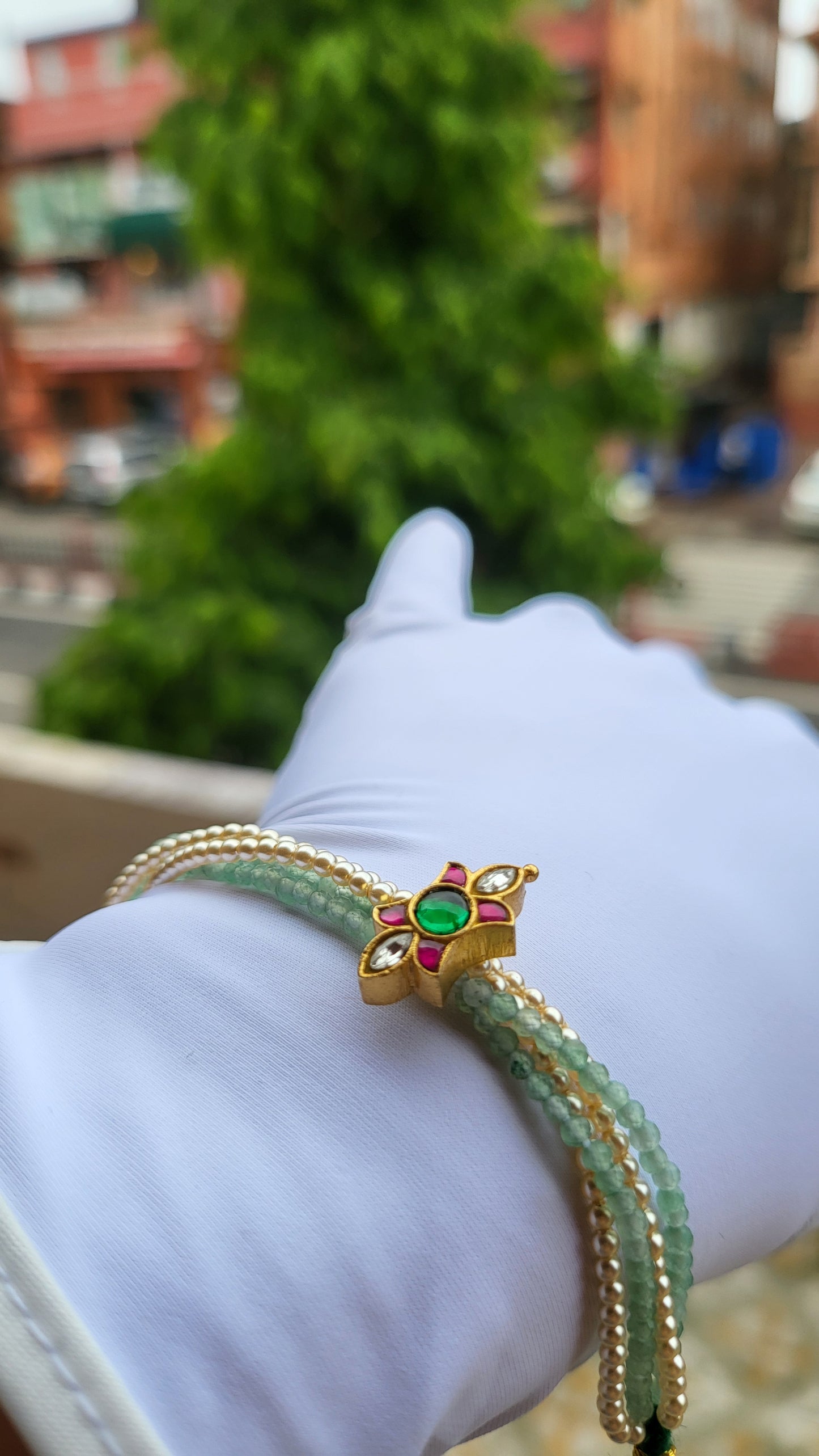 Kundan-Inspired Floral Bracelet with Green Beads & Pearl Strands