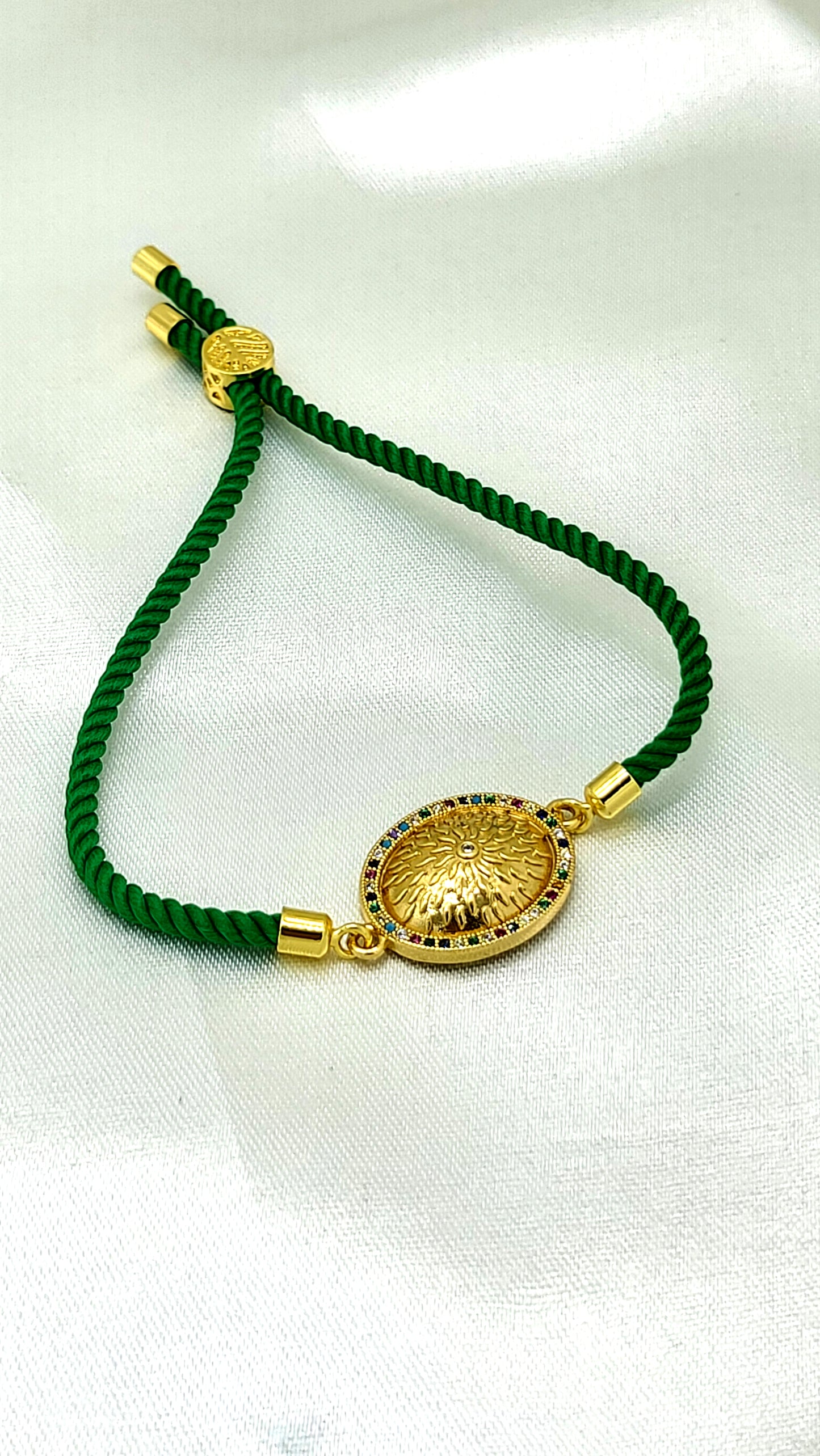 Royal Emblem Rakhi with Multicolor Accents – Green Cord