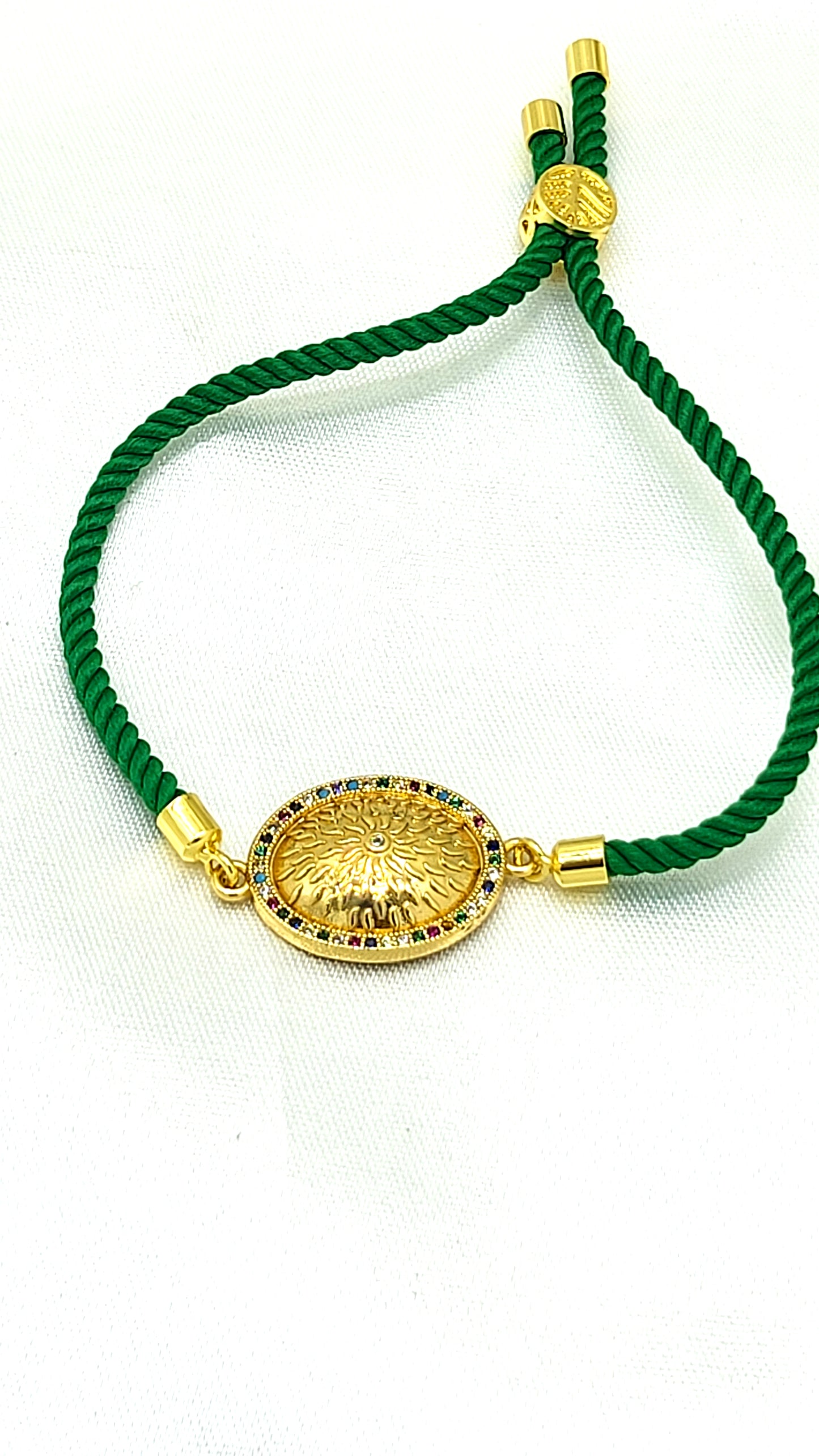 Royal Emblem Rakhi with Multicolor Accents – Green Cord